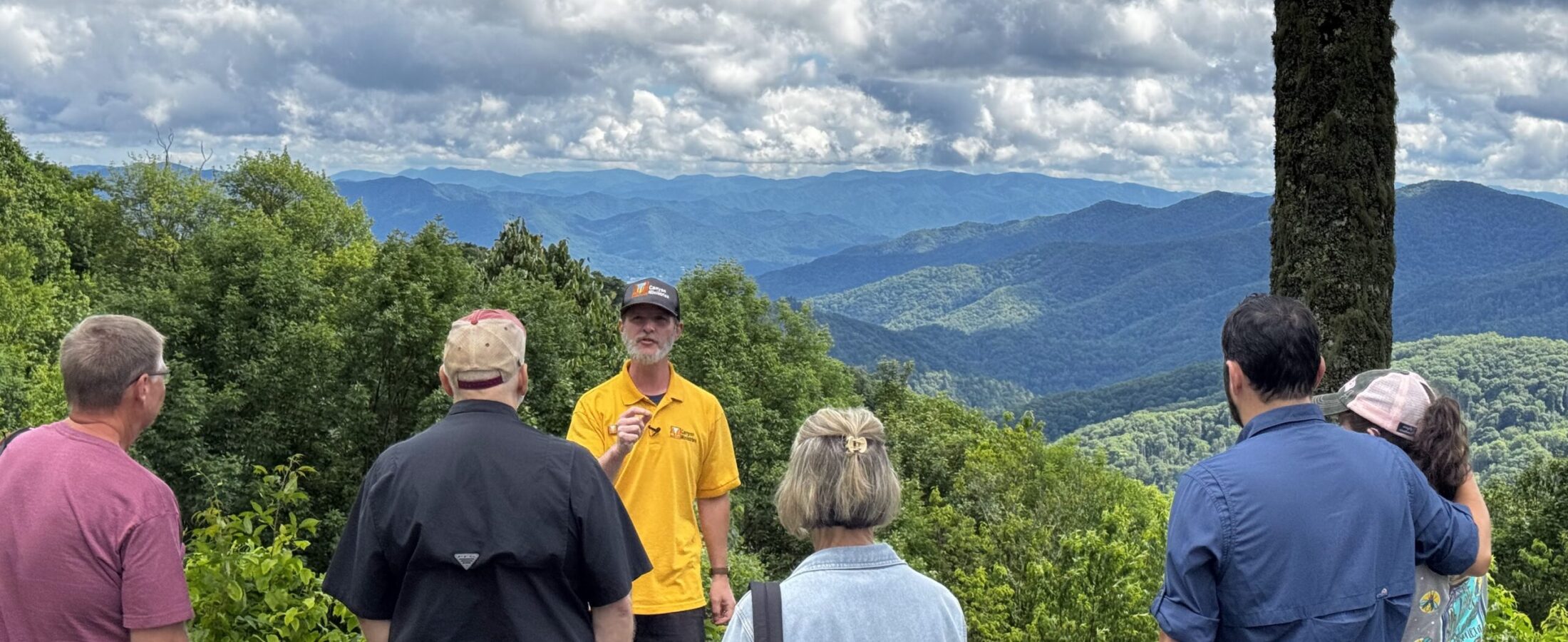 Luke Wayne of Canyon Ministries teaching a tour group before panoramic ridges in Great Smoky Mountains National Park
