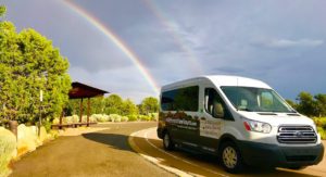 Canyon Ministries van beneath a rainbow at Desert View, Grand Canyon