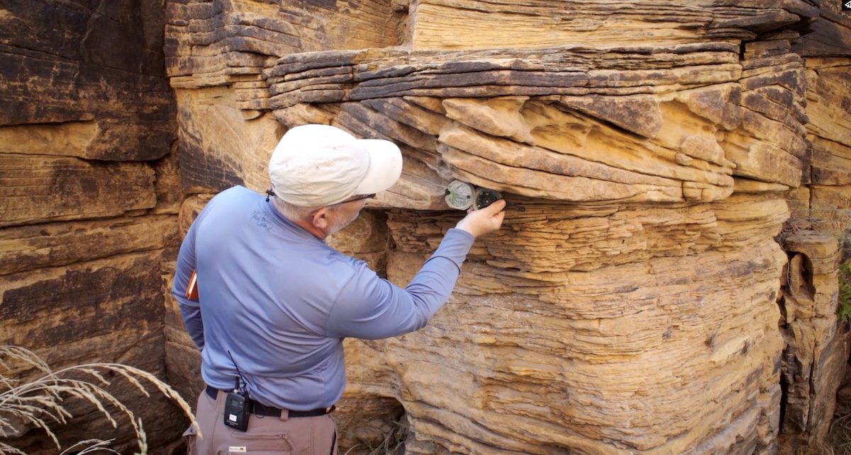 Dr. John Whitmore taking measurements of the Coconino Sandstone