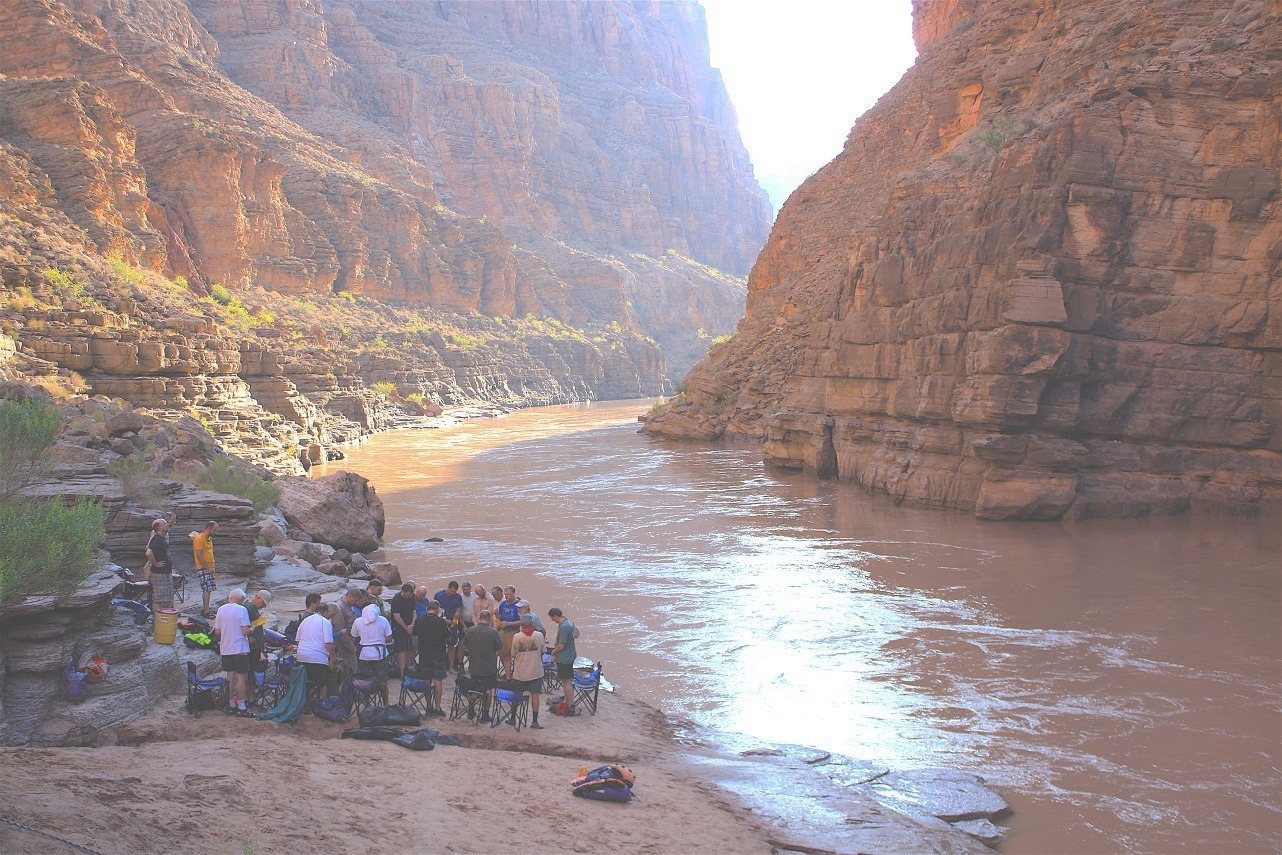 Grand Canyon Christian Leaders Trip Chair Circle The group listened intently as the Canyon Ministries guide shared insights about the areas geological history and its significance. The sound of the river complemented the serene atmosphere, fostering a sense of connection to nature and deeper contemplation. Voices were hushed, respecting the sacredness of their surroundings while engaging in meaningful conversations and personal reflections along the canyons edge.