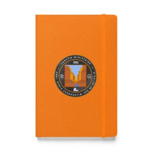 The notebook is hardcover, with an orange cover, secured by an elastic band. It displays a circular Canyon Ministries logo that shows a canyon and river, bordered by the phrase A Voice in the Wilderness Since 1982.