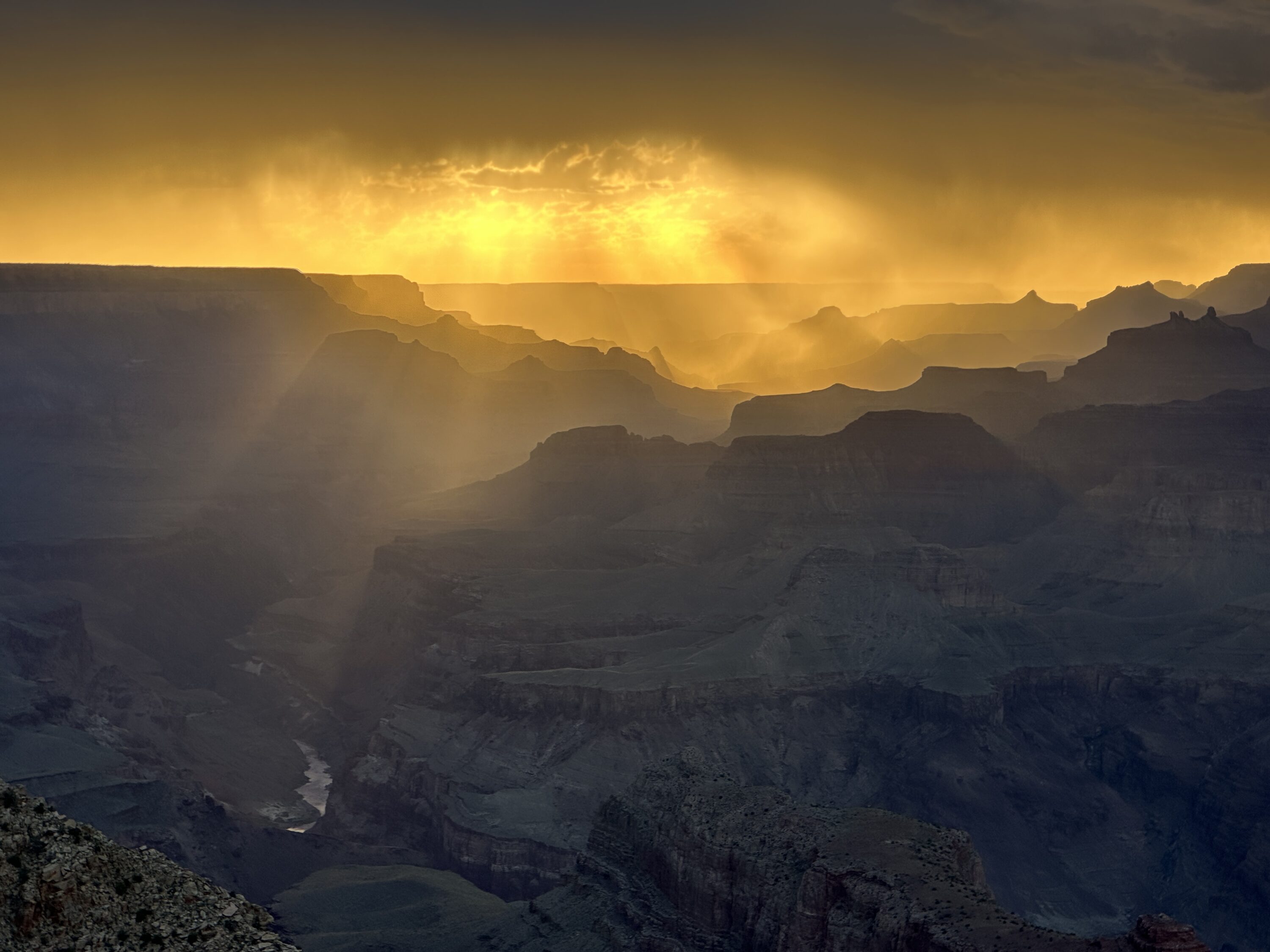 Golden sunset over the Grand Canyon and Colorado River photographed by Nate Loper