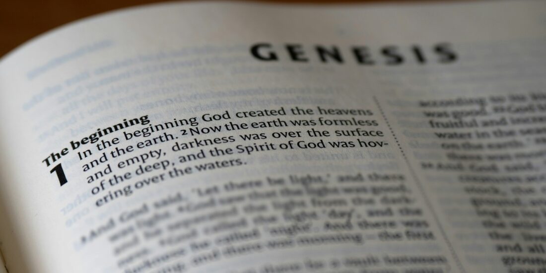 Open Bible representing the book of Genesis