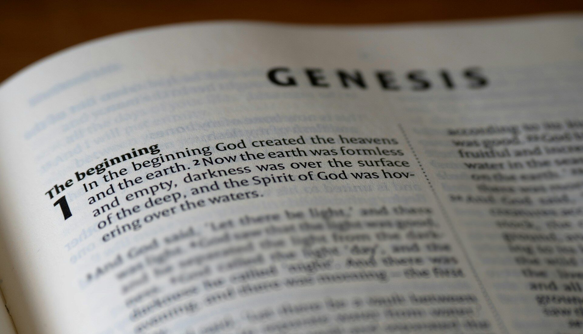Open Bible representing the book of Genesis